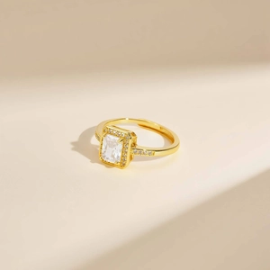Macro detail of adjustable gold ring with emerald cut zircon and pave diamond halo
