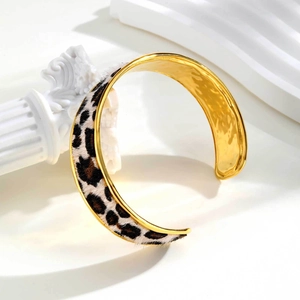 Detailed view of the leopard print faux fur texture on a gold stainless steel cuff bracelet