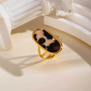 Detailed close-up of a gold oval ring featuring a vintage leopard print fabric inlay