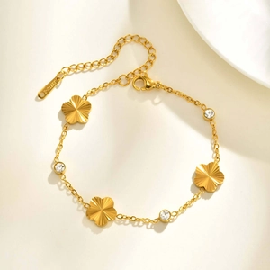 Elegant gold stainless steel bracelet with five-petal floral charms and sparkling zircons