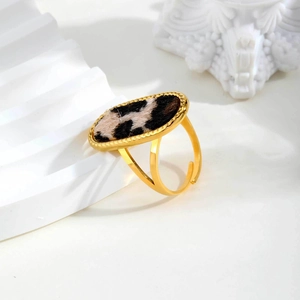 Macro detail of gold oval leopard print ring with textured animal hair inlay