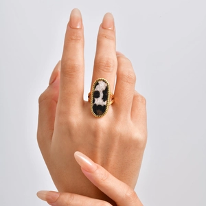 Macro shot of gold oval ring featuring black and white animal print textured hair inlay