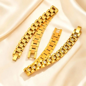 Three elegant gold stainless steel zircon bracelets on luxury champagne satin fabric