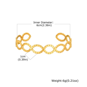 Detail view of 18K gold plated twisted bangle with dimensions 6cm diameter and 1cm width