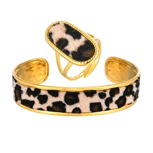Gold stainless steel wide cuff bracelet and oval ring set featuring leopard print pattern