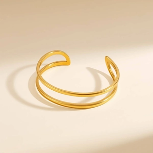 Detailed view of gold double-layer geometric open bangle with a high-polished finish