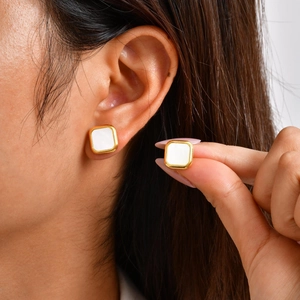 Square gold stainless steel stud earrings with white mother of pearl inlay on model