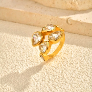 Macro detail of gold teardrop zircon ring stones on minimalist stone platform