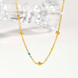 Golden stainless steel beaded necklace with colorful drip glue accents in minimalist style