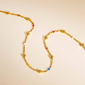 Detail of colorful beads and gold stainless steel chain showing texture and vibrant colors