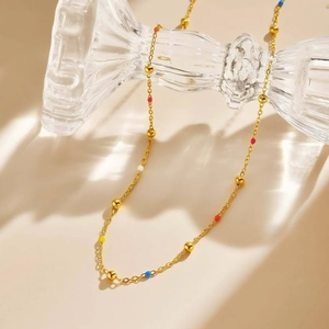 Gold stainless steel beaded necklace with colorful drip oil charms in a boho chic style