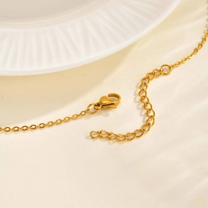 Close-up of gold stainless steel necklace chain with lobster clasp and adjustable links