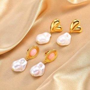 Vintage stainless steel earrings with baroque pearls and pink gemstones on silk fabric
