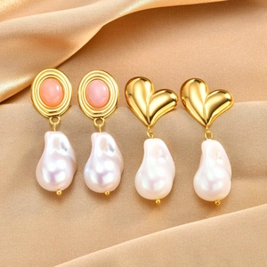 Vintage gold drop earrings with oval stones and baroque pearls on silk fabric