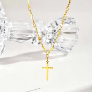 Polished gold stainless steel cross pendant necklace with a unique wavy link chain