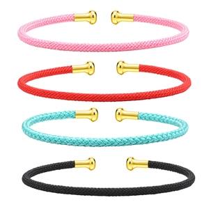 Four colorful woven C-shape open bracelets in pink, red, cyan, and black with gold tips