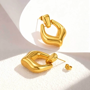Macro shot of 18K gold plated hollow geometric earrings with polished mirror finish