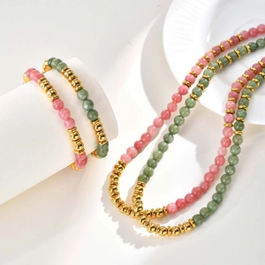 Detail view of strawberry quartz and aventurine beads with gold metallic spacers