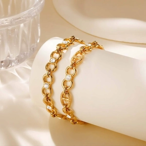 Gold stainless steel intertwined link bracelet set with white cubic zirconia accents