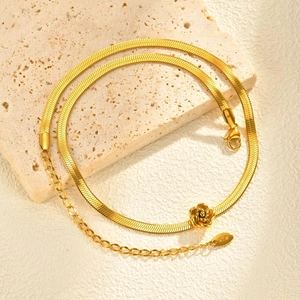 Detail of gold rose flower pendant on snake chain with K18 hallmark and lobster clasp