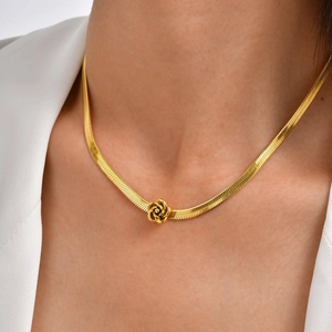 Close-up of a gold stainless steel snake chain necklace featuring a 3D rose flower pendant