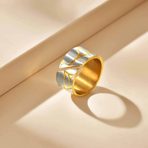 Detailed close-up of mixed-color pebble ring with golden finish and silver brushed texture