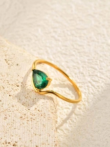 Detailed view of teardrop green zircon stone on gold-plated stainless steel ring band