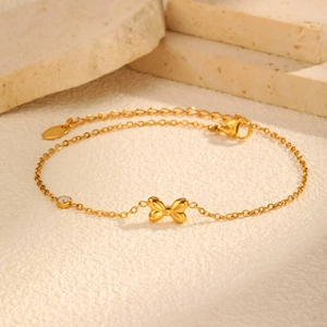 Bracelet de cheville en acier plaqué or 18 carats avec nœud élégant et zircon brillant