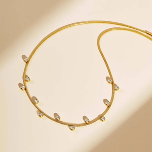 Gold round snake chain necklace featuring elegant white zircon dangling pendants