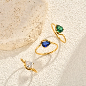 Elegant gold-plated wave rings featuring pear-cut zircon stones in green, blue, and clear