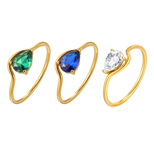 Three gold stainless steel rings with pear-shaped emerald, sapphire, and clear zircons