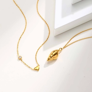 Detail von Goldketten mit Muschel Herzanhänger und Zirkonstein Verzierungen
