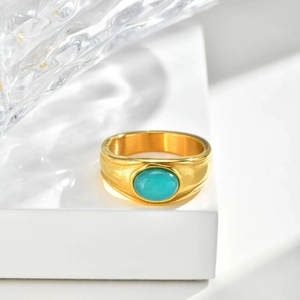 Close-up of vintage gold stainless steel ring with oval amazonite stone inlay