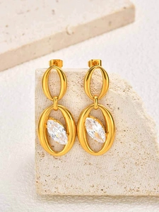Detail view of gold oval earrings with marquise-cut crystal on stone pedestal