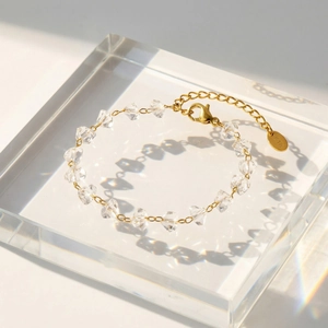 Macro shot of 18K gold-plated chain bracelet featuring irregular clear crystal beads