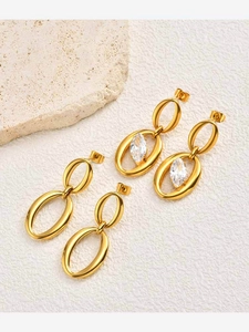 Detail of gold oval geometric earrings with a marquise zircon stone on stone base