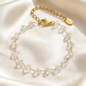 Elegant 18K gold-plated irregular glass bead bracelet for women on cream silk background