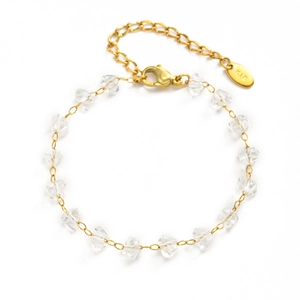 Detailed macro view of 18K gold chain bracelet with clear faceted crystal beads