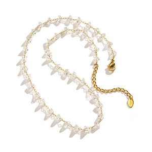 Detailed close-up of 18K gold-plated clasp with clear crystal beads and extension chain