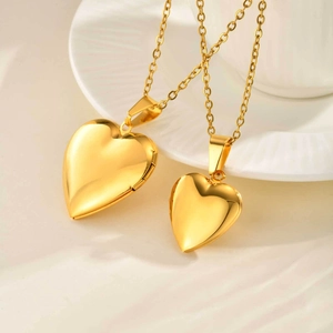 Golden stainless steel heart locket pendant necklace with polished finish on white porcelain
