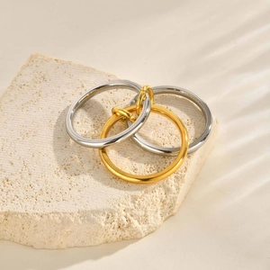 Detail of three-link interlocking polished rings in gold and silver mixed tones