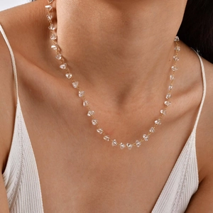 Gold stainless steel necklace with irregular clear stone beads worn by a model