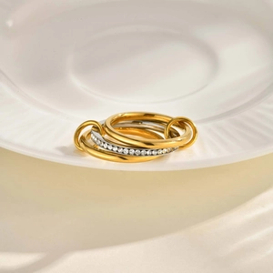 Macro detail of interlocking three-band ring with gold and silver zircon pavé finish