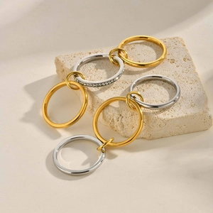 Two-tone layered stainless steel rings with gold and silver bands and micro-pave zircon
