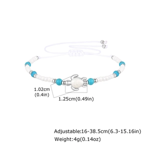 Detail of adjustable turquoise beaded anklet featuring a small silver sea turtle charm