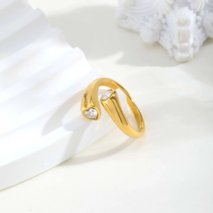 Close-up of golden open ring featuring heart-shaped and round cut zircon stones