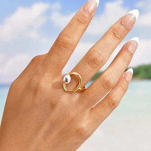 Minimalist gold and silver mixed metal geometric ring with steel bead accent on model