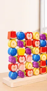 Detail of smooth wooden fruit stacking blocks with rounded edges for toddler motor skills