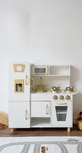 Close-up of wooden toy kitchen sink with gold faucet and stainless steel bowls