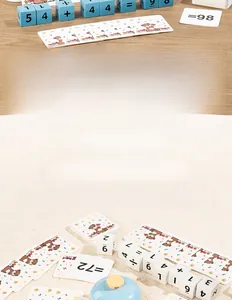 Close-up of wooden math blocks with number cards and a blue response bell for learning